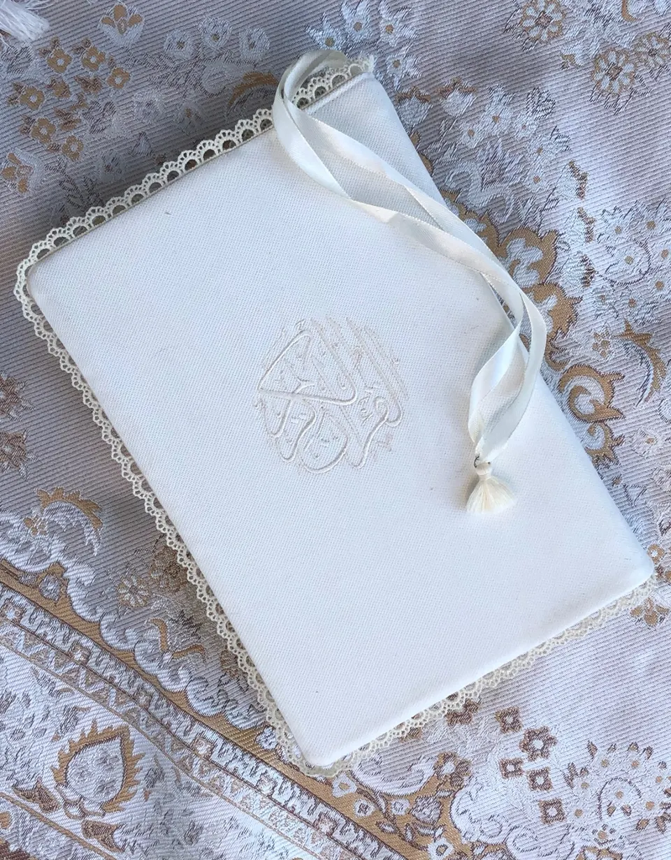 White cotton book cover, round Al-Quran Al-Karim calligraphy embroidered white on white, beige crown lace, cream ribbon with tassel