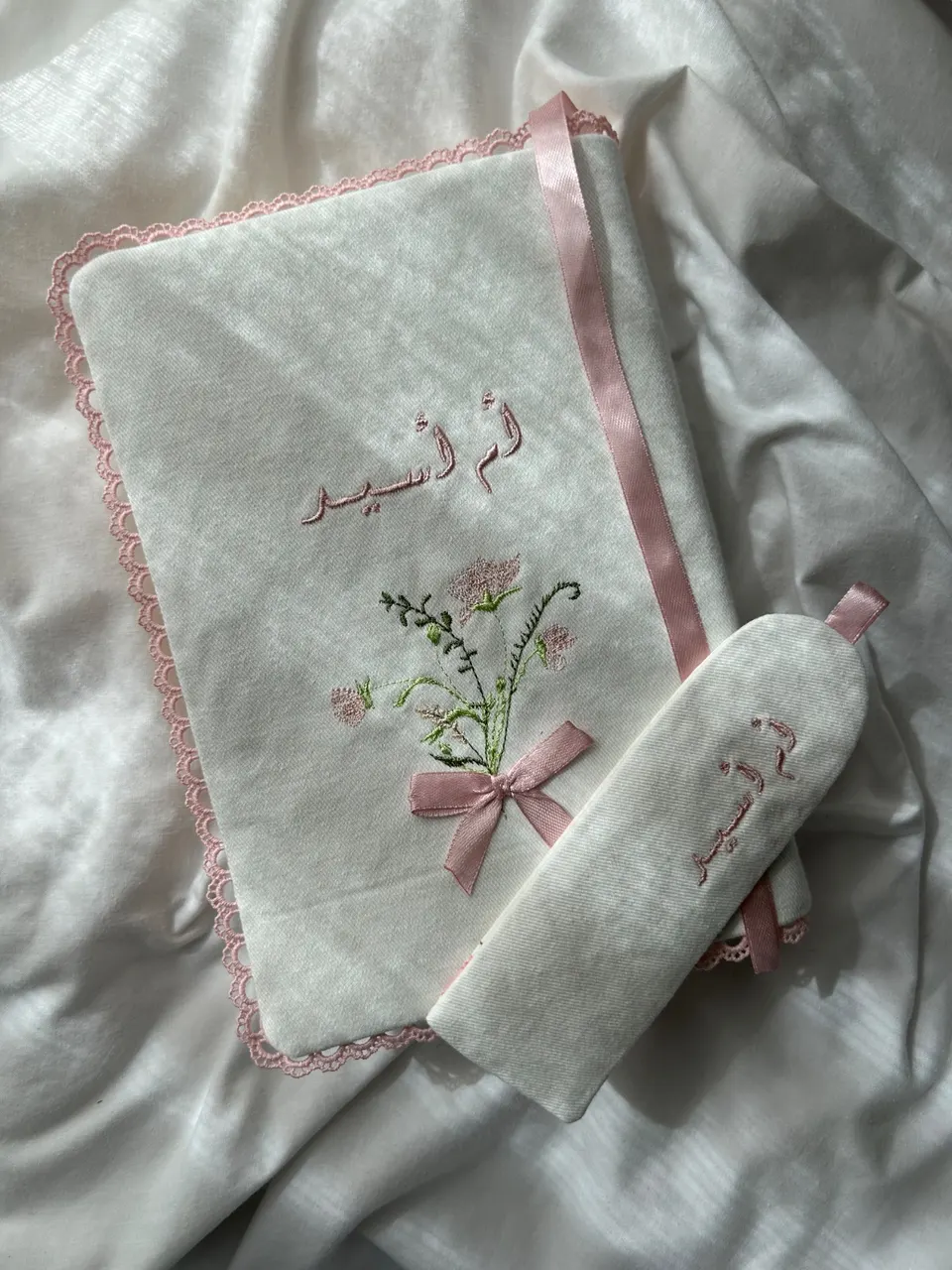 White cotton book cover, flower bouquet and Arabic kunya embroidered in pink, pink crown lace, pink ribbon and matching bookmark