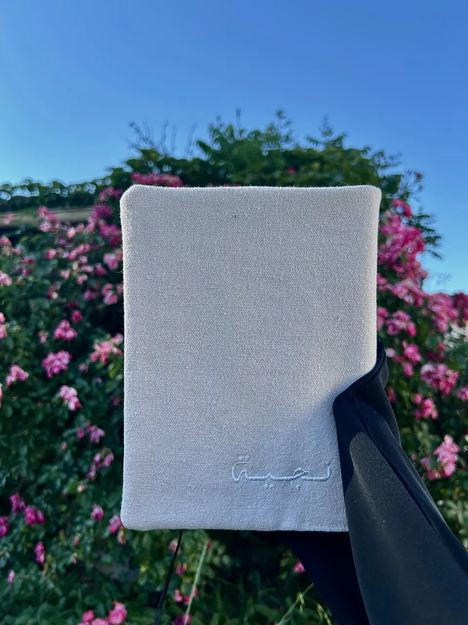 Minimalist speckled beige cotton book cover, Arabic name calligraphy embroidered in white thread